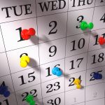 Close up , colorful pushpins on calendar